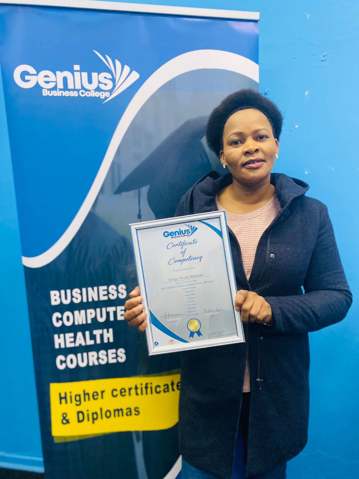 Genius Business College learner celebrating certificate achievement
